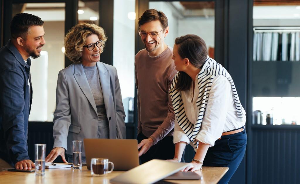 Employees working together after IT downtime is over.
